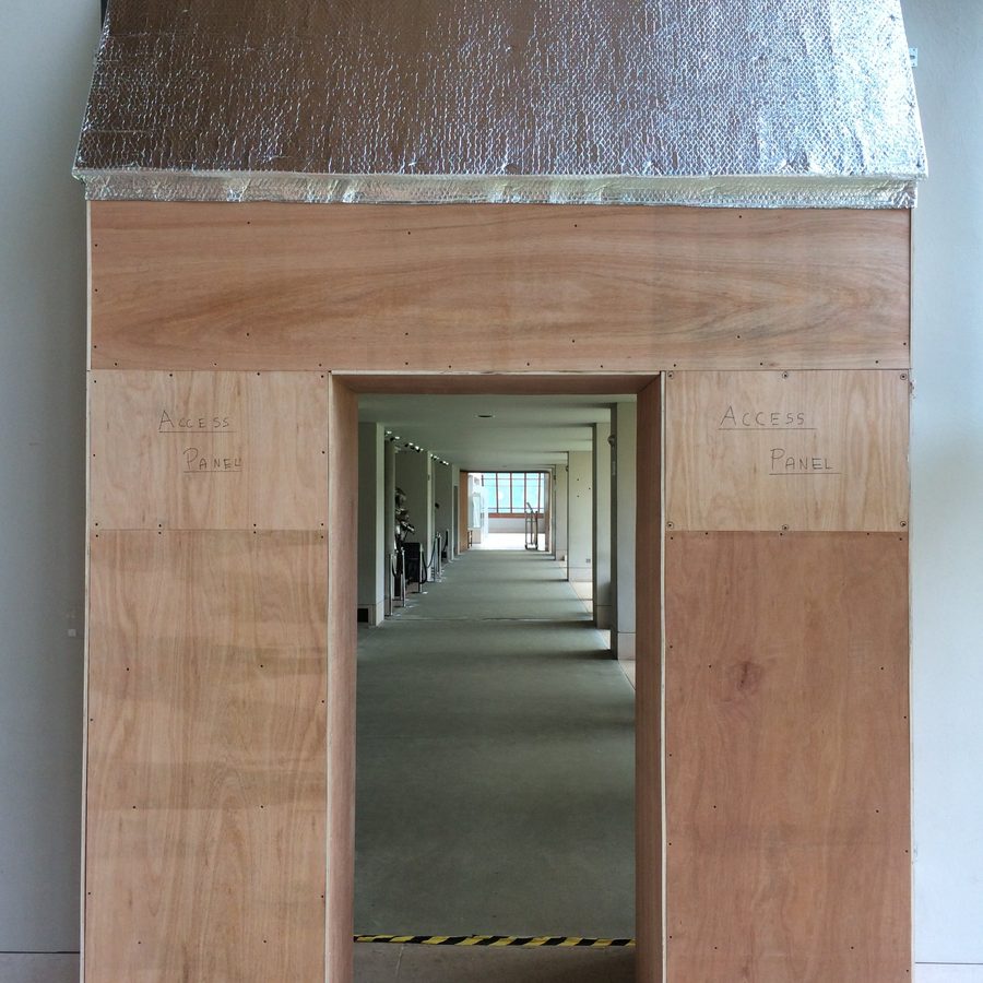 Temporary protective enclosure built around a doorway, with access panels