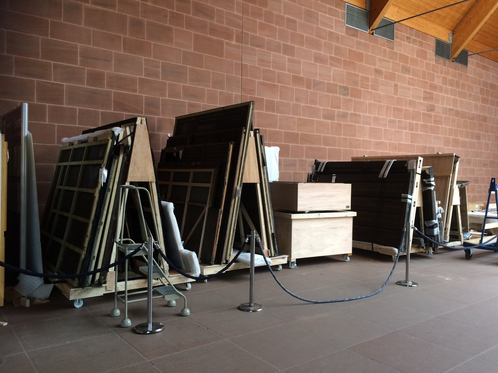 Dismantled timber structures from the Burrell Collection on A-frame racks and in crates