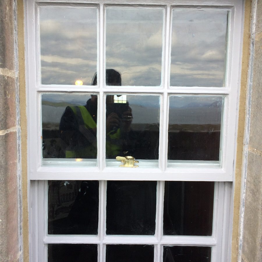 Restored sash window with brass fastener