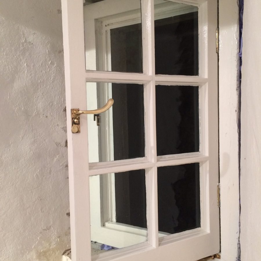 Casement being fitted back into its stone reveal