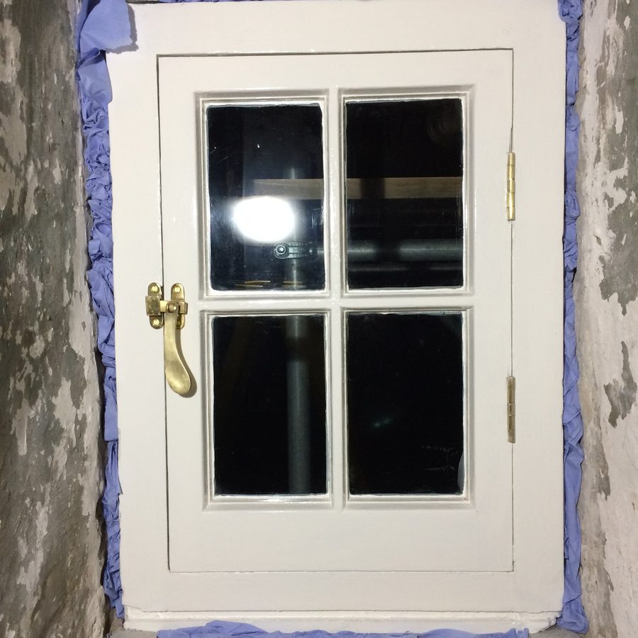 Restored casement with brass handle and stay