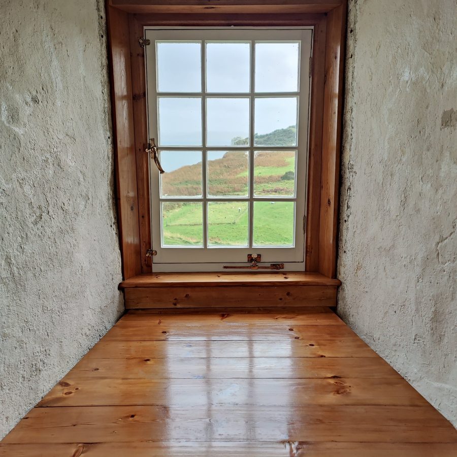 Restored window and boarded floor in a window recess