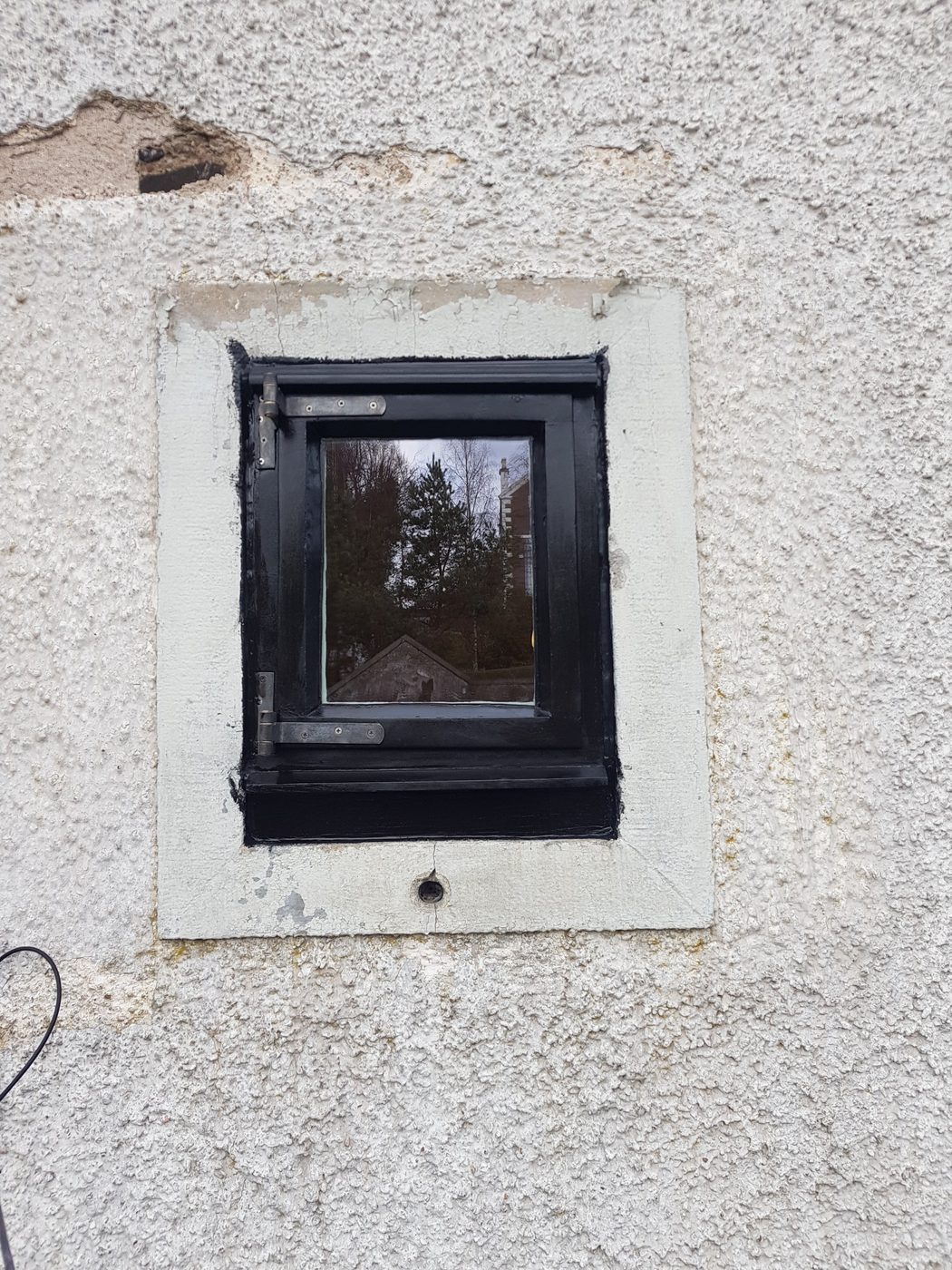 Small casement reinstalled in the gable wall