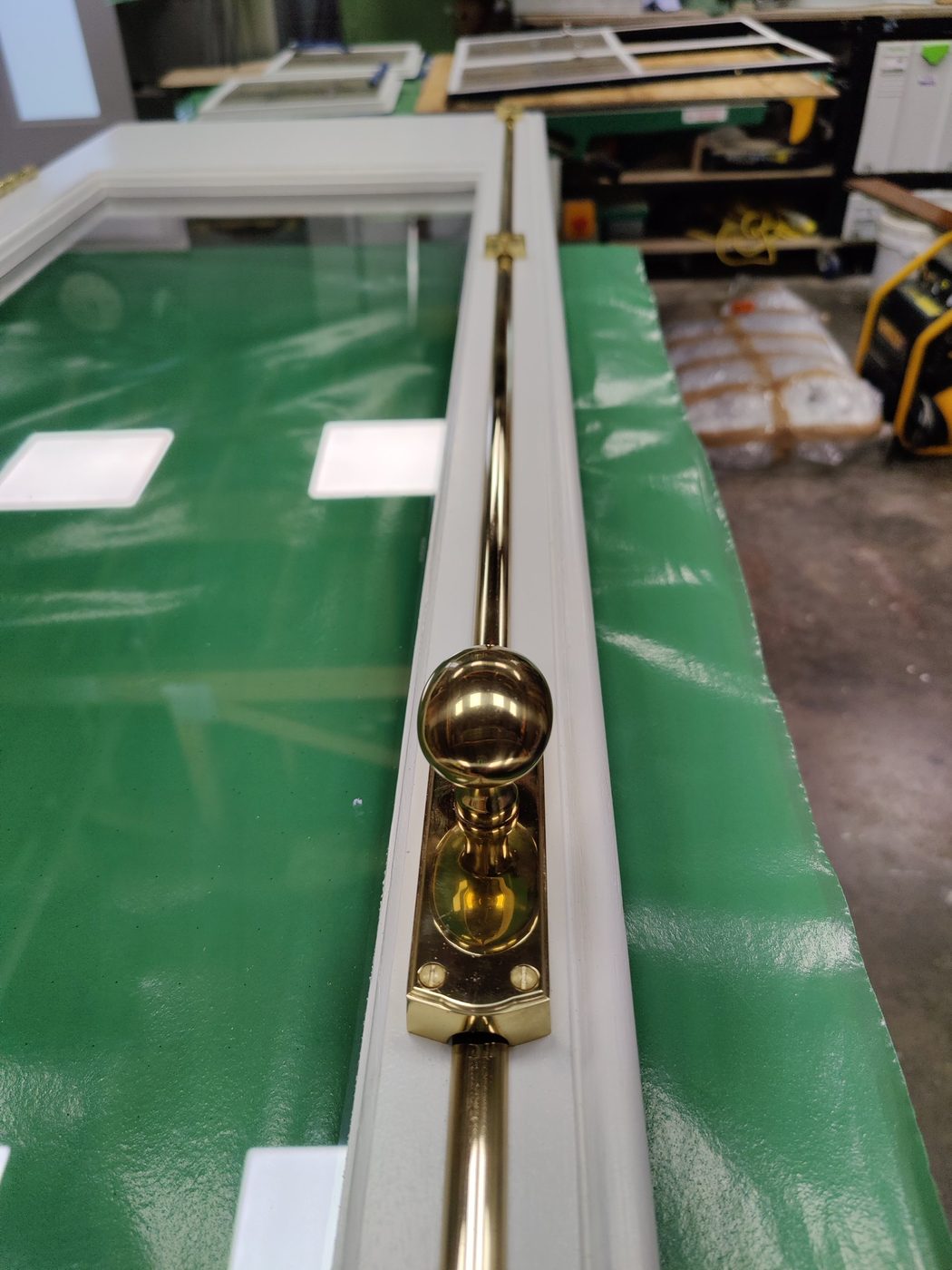 Polished brass cremorne bolt on a restored casement