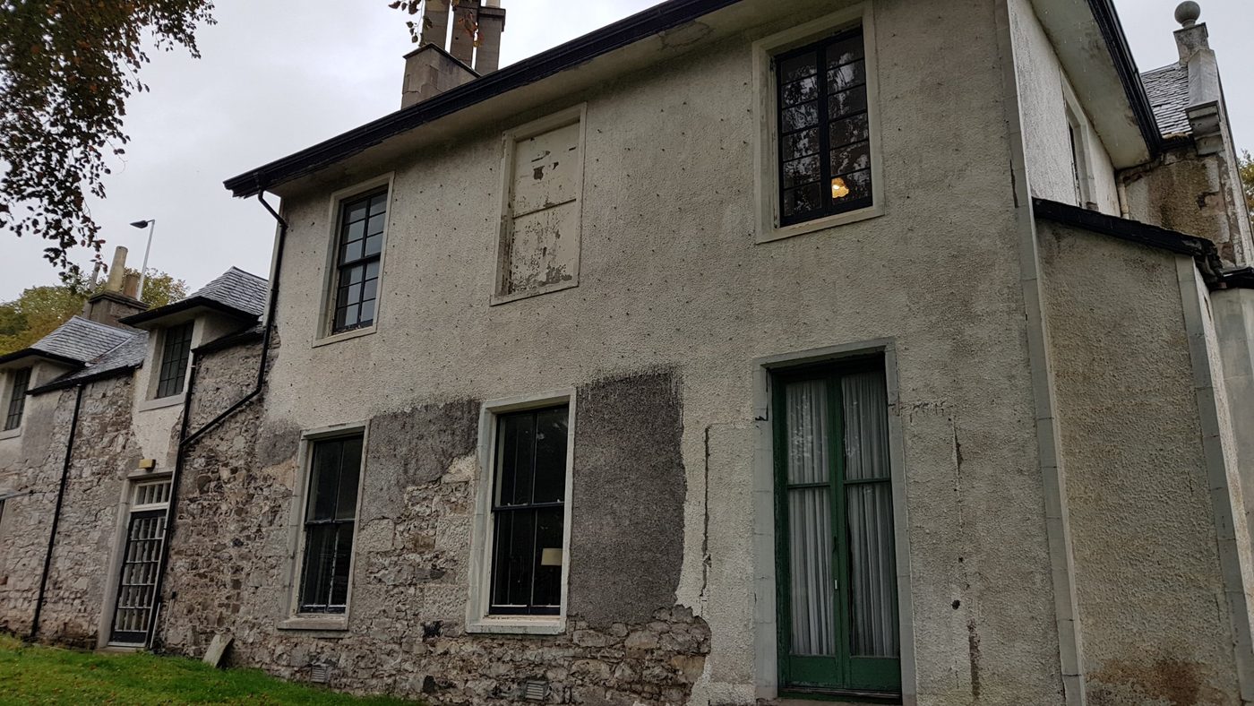 Side elevation before restoration, with patched render and worn joinery