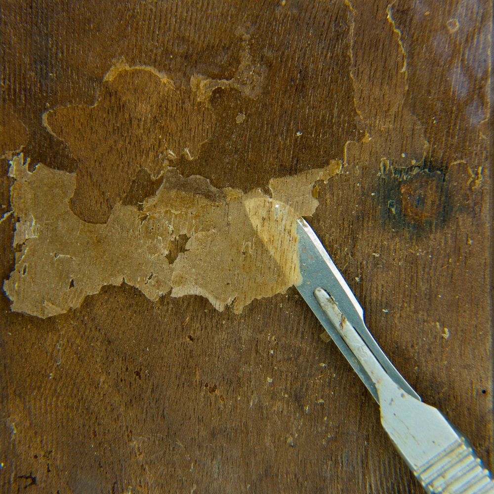 Scalpel work on a decorative wooden surface