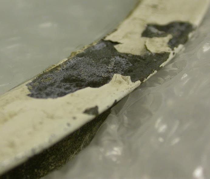 Detail of white paint lost from the metal frame
