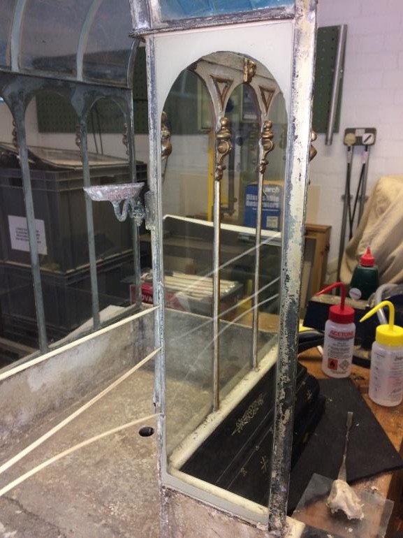 New glass pane fitted in the case with fresh linseed oil putty