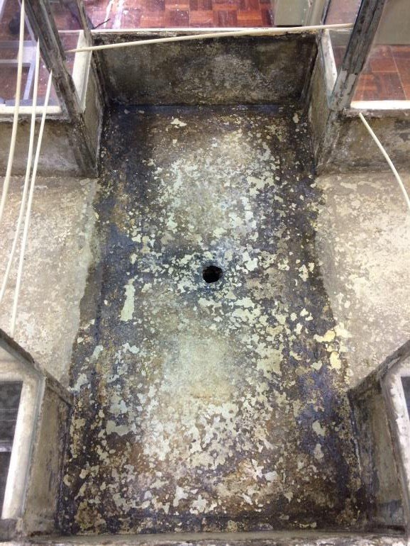 Corroded metal floor of the case being consolidated