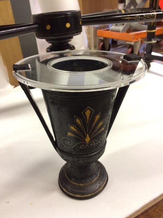 Clear tubes leading from the case to a Perspex liner inside the vase